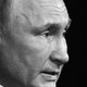 Black-and-white, close-up shot of Vladimir Putin looking resolute in profile