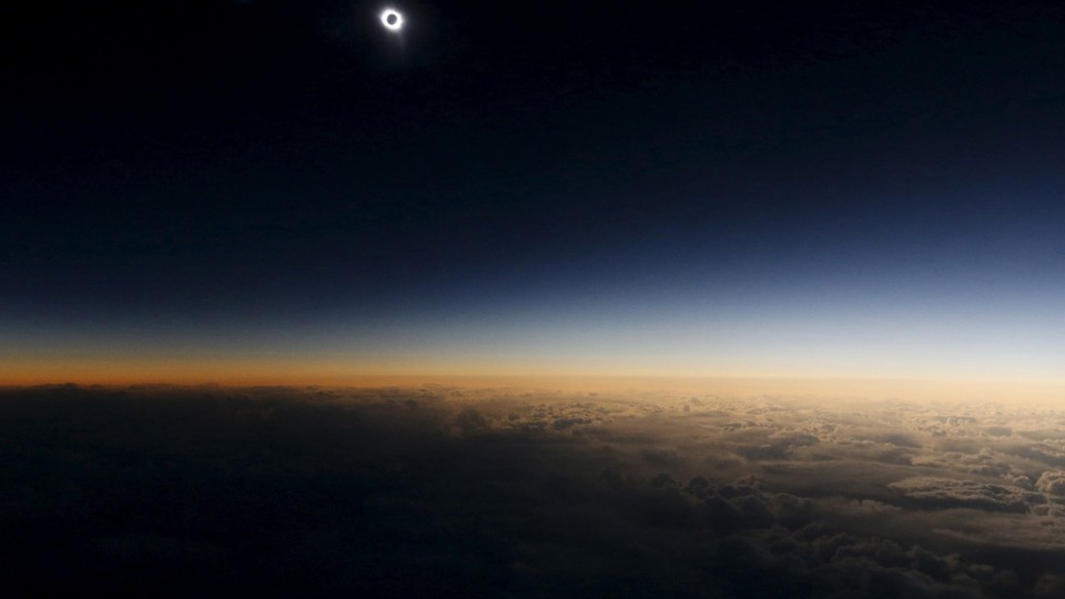 A total solar eclipse as seen from the window of a plane