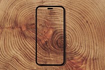 A transparent phone against a wood-grain background