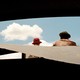 Father and son looking at clouds on a sunny day