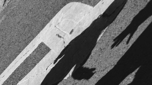 shadow of an adult hand reaching for a child's