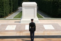 A soldier stands in front of the Tomb of the Unknown Soldier