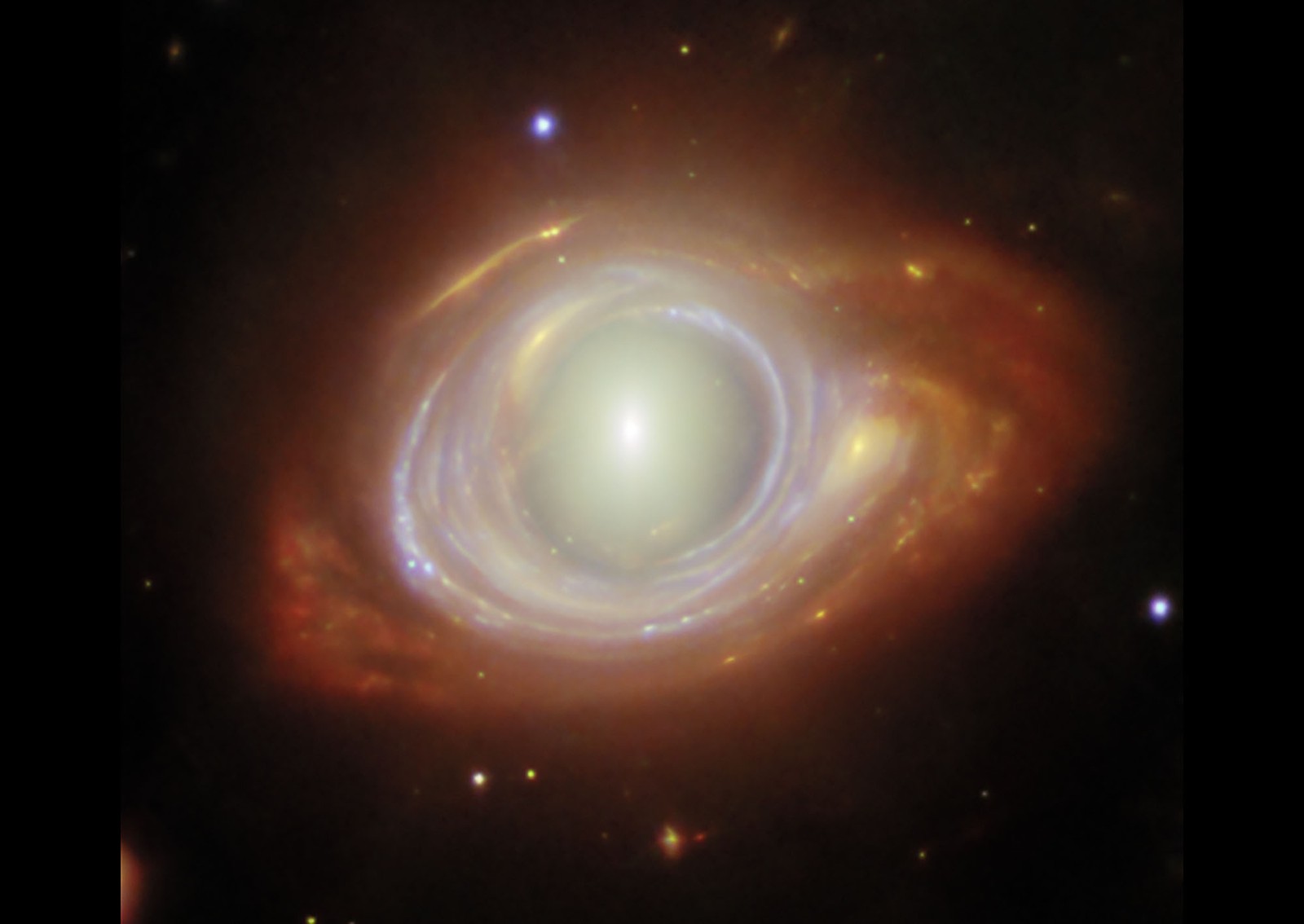 The center of a distant spiral galaxy appears warped, bulging out as if seen through a thick magnifying lens.