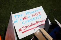 A sign reads "The absence of no is not consent. #Stanfordknows"