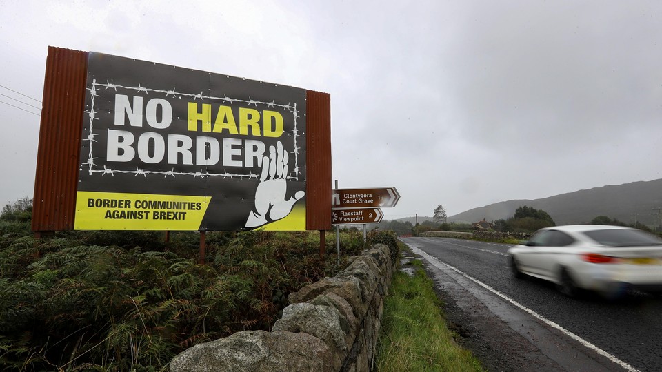 A billboard erected at the Irish border reads "No hard border: Border Communities Against Brexit."