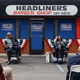 Kamala Harris speaks as part of a panel outside a barbershop.
