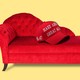 A graphic illustration of a red MAGA cap atop a red psychiatrist’s couch, on a pale-yellow background