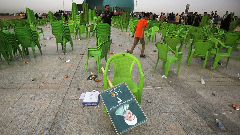 A field of empty chairs with a discarded campaign poster