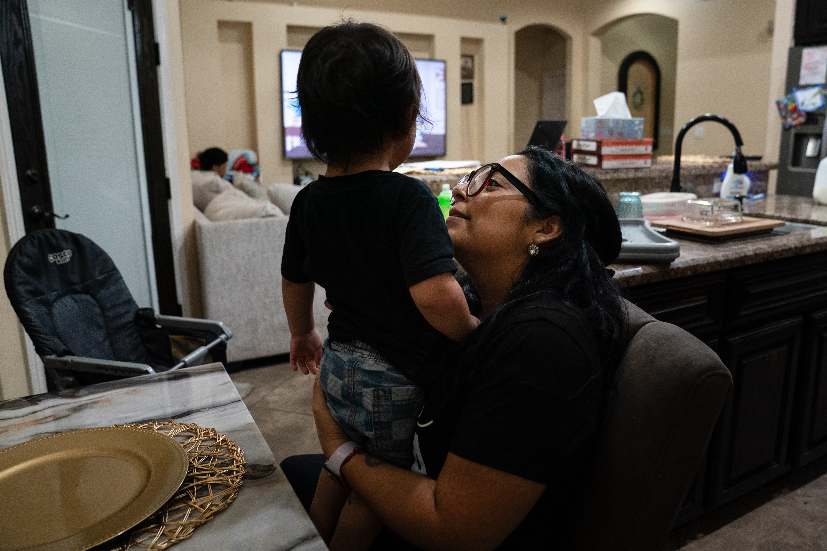 a woman holds a small child in her lap 