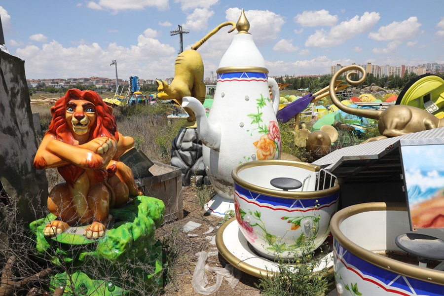 Theme-park features are seen piled in a field.