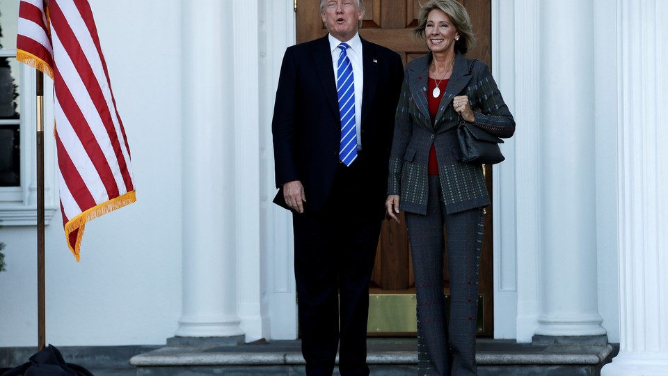 President-elect Donald Trump stands with Education Secretary-nominee Betsy DeVos.
