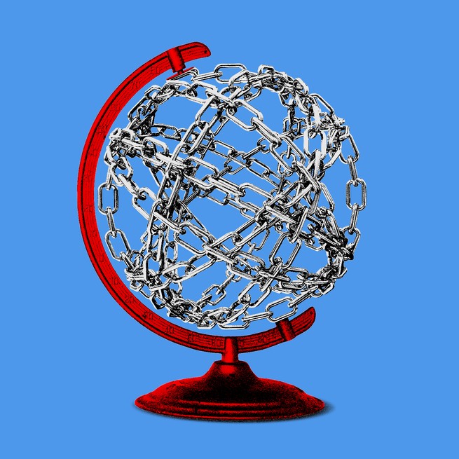 A globe made up of metal chains on a red globe meridian and stand, on a light blue background.