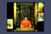 An illustration of a man in a red shirt sitting at a counter in a video store