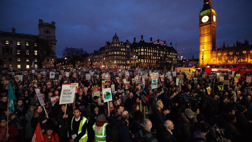 Thousands of protesters holding placards take part in a rally in Parliament Square against President Donald Trump's state visit to the U.K.