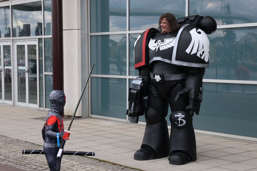Two people outside a building wearing fantasy character costumes