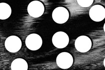 white pill-like circles against a black-and-white blurred image reminiscence of an ultrasound