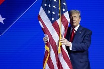 Donald Trump hugs an American flag