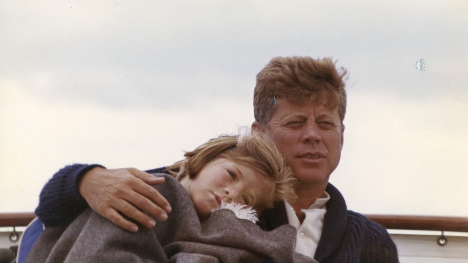 President John F. Kennedy sits on a yacht with his daughter Caroline off Hyannis Port, Massachusetts, in August 1963.