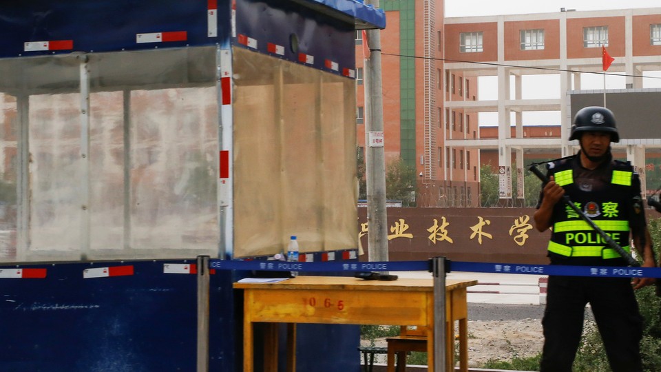 A guard stands outside what is officially known as a "vocational skills education center" in Hotan in Xinjiang in September 2018.