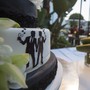 A wedding cake with two figures holding hands
