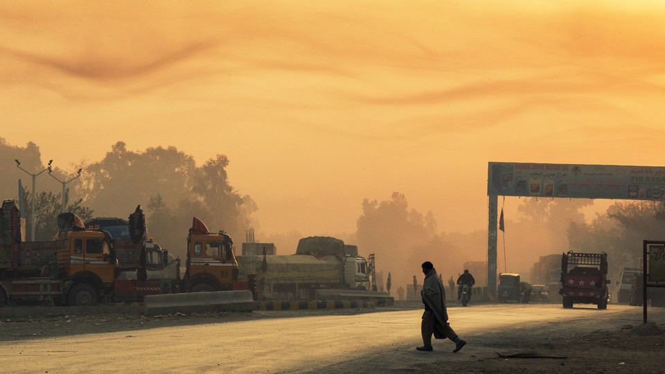 A man crosses the street near Forward Operating Base Fenty in Afghanistan's Nangarhar province on December 19, 2014.