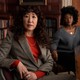 Sandra Oh sitting at a table in The Chair