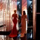 Two presenters walking offstage at the Oscars