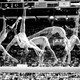 A series of freeze-frames of a gymnast performing a flip