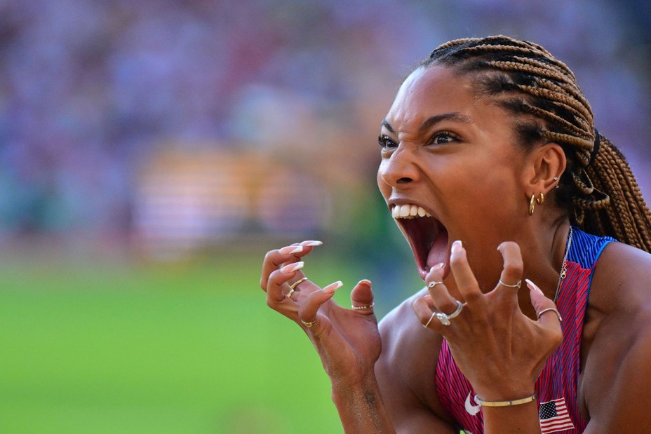 An athlete makes a dramatic expression after an event.