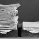 A black-and-white photo of stacks of papers