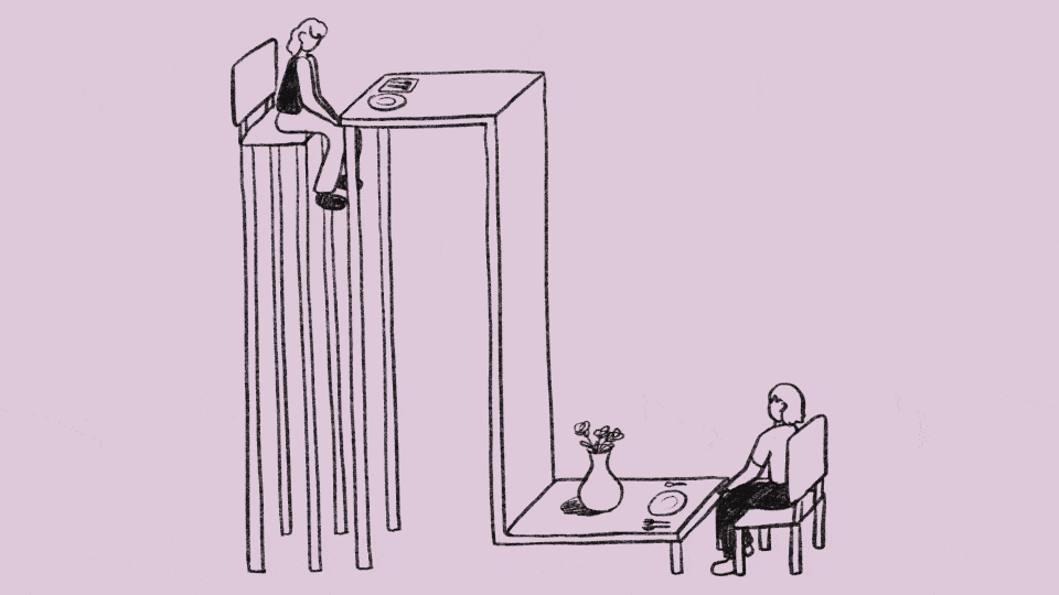 A gif of two people sitting across from each other at a table, with each person rising above the other like a seesaw