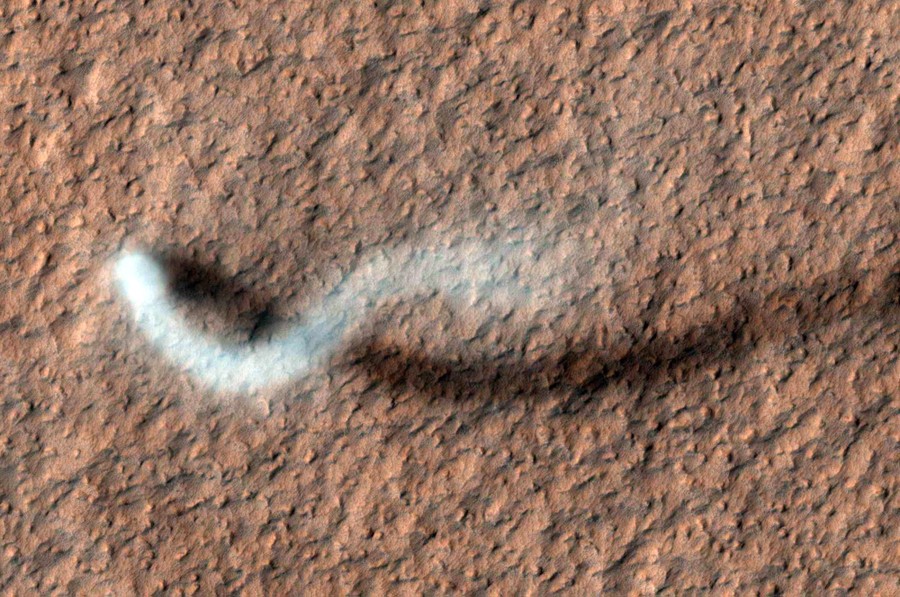 An aerial view of a twisting dust devil on Mars