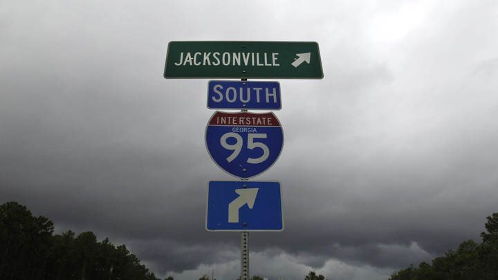 Blue and green I-95 interstate signs on a stormy day