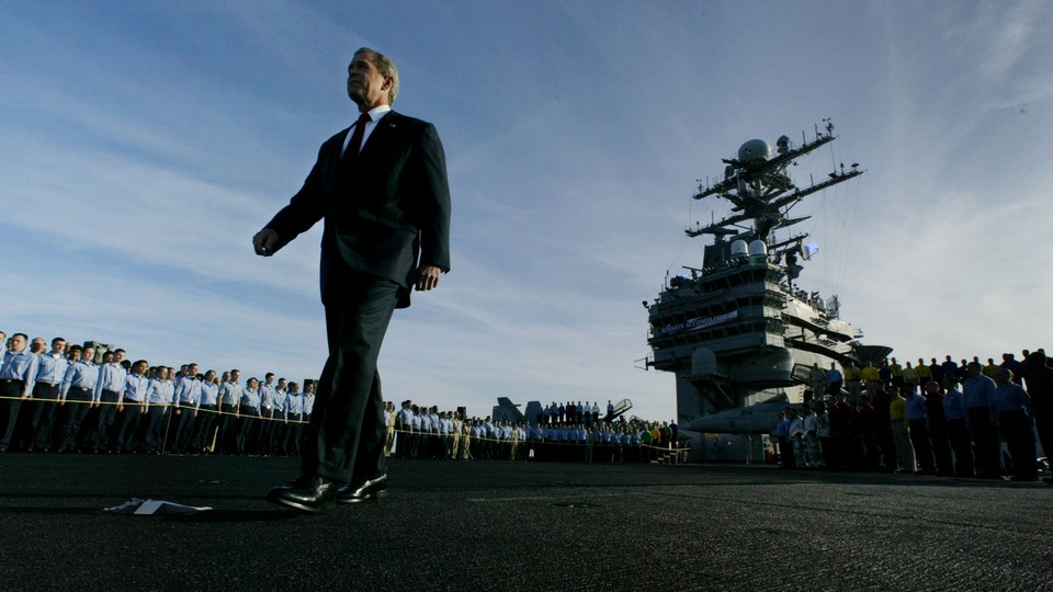 George W. Bush walked past crew members of the aircraft carrier USS Abraham Lincoln on May 1, 2003, to declare major combat in Iraq over.