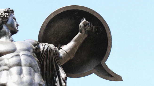 A marble statue holding a shield