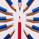 Blue pencils pointing at a red one