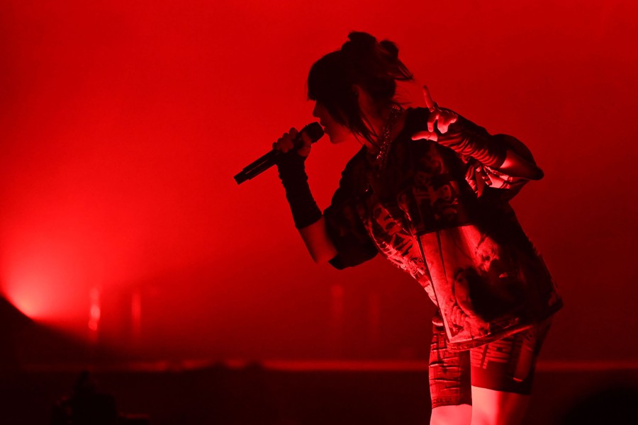 A performer sings into a microphone.