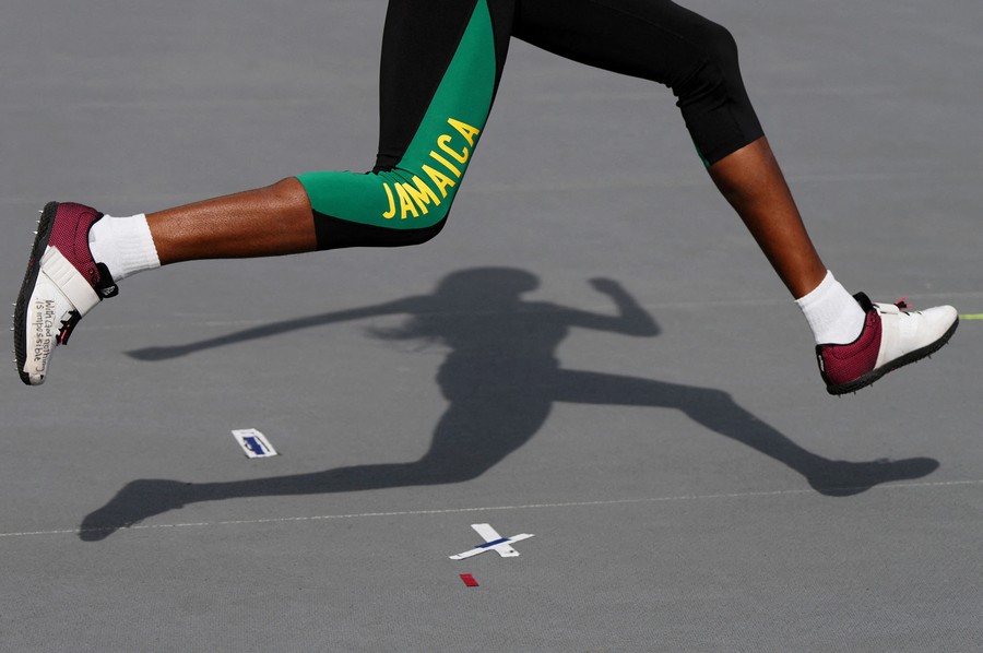 An athlete runs before a high jump.