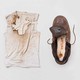 photo of burned undershirt, leather shoe with burn marks on insole, and straw hat with large jagged hole