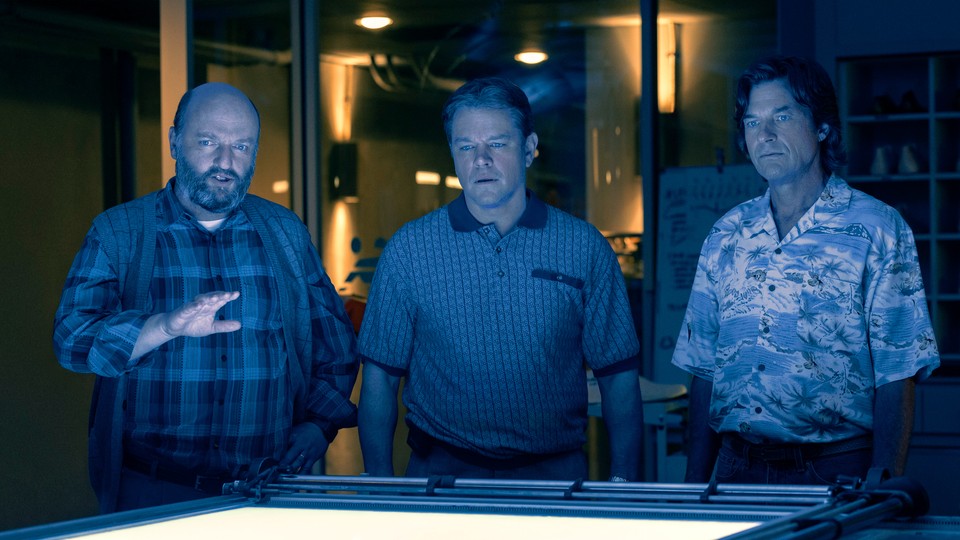 Matthew Maher, Matt Damon, and Jason Bateman, cast in blue light, look at an image proof in the movie "Air"