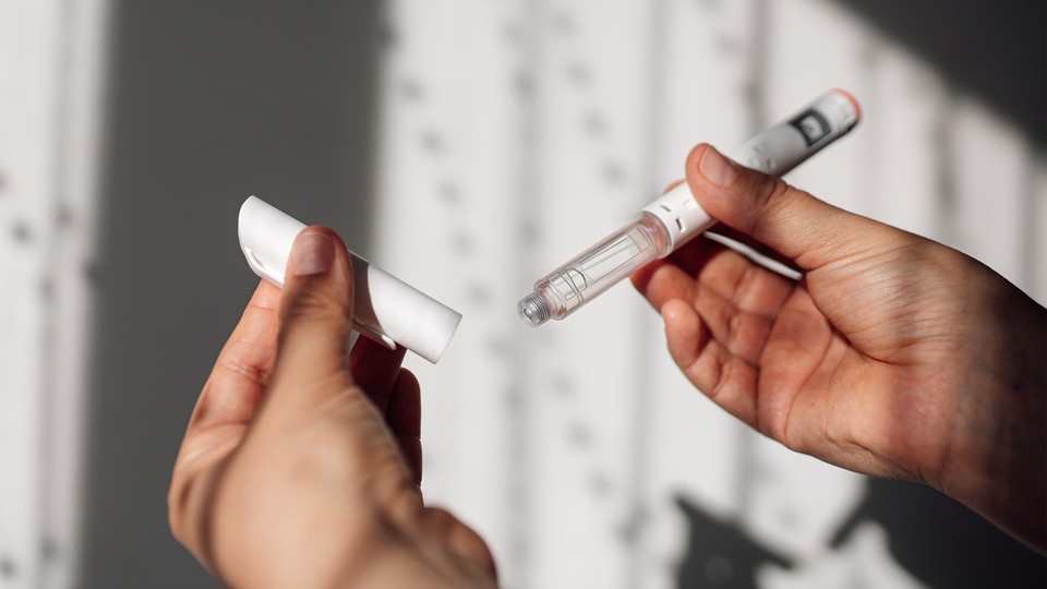 Semaglutide injection pen or cartridge pen for diabetics and weight loss in female hand.