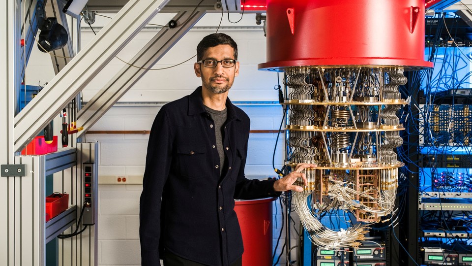 Google CEO Sundar Pichai stands beside a quantum computer.