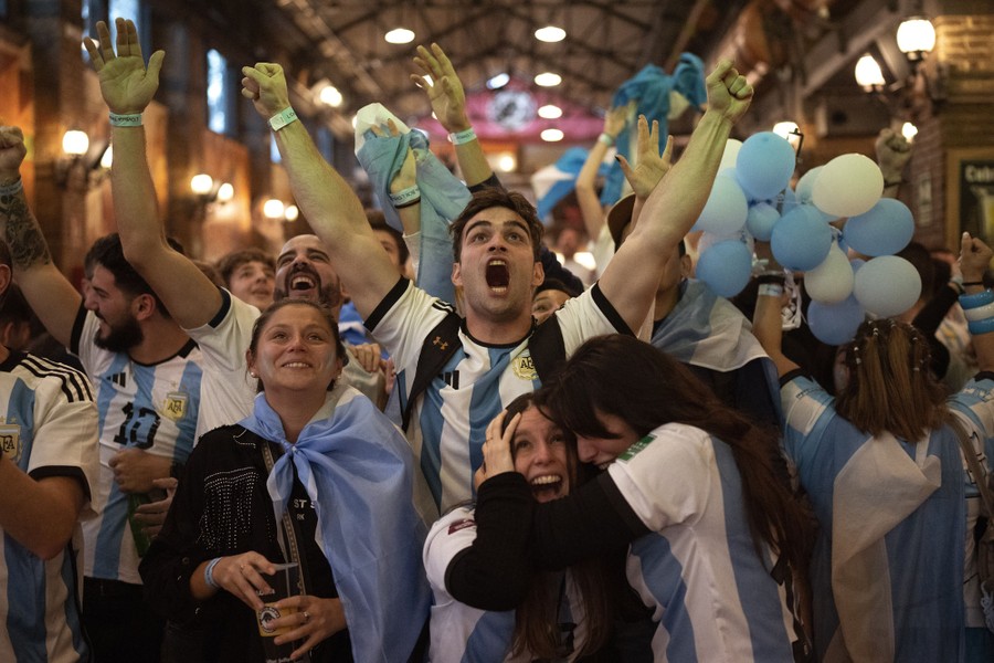 A group of soccer fans celebrates together.