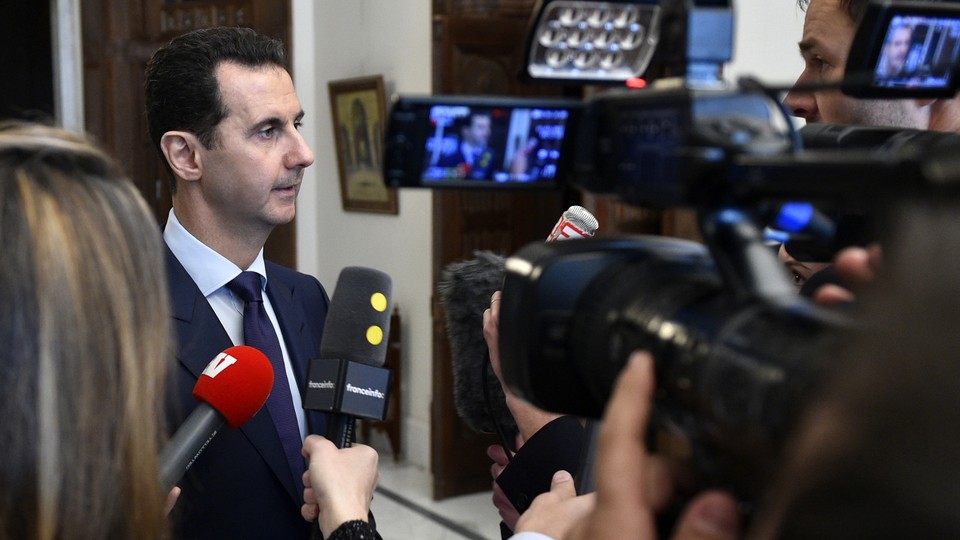 Syrian President Bashar al-Assad speaks with French journalists in Damascus on January 9.