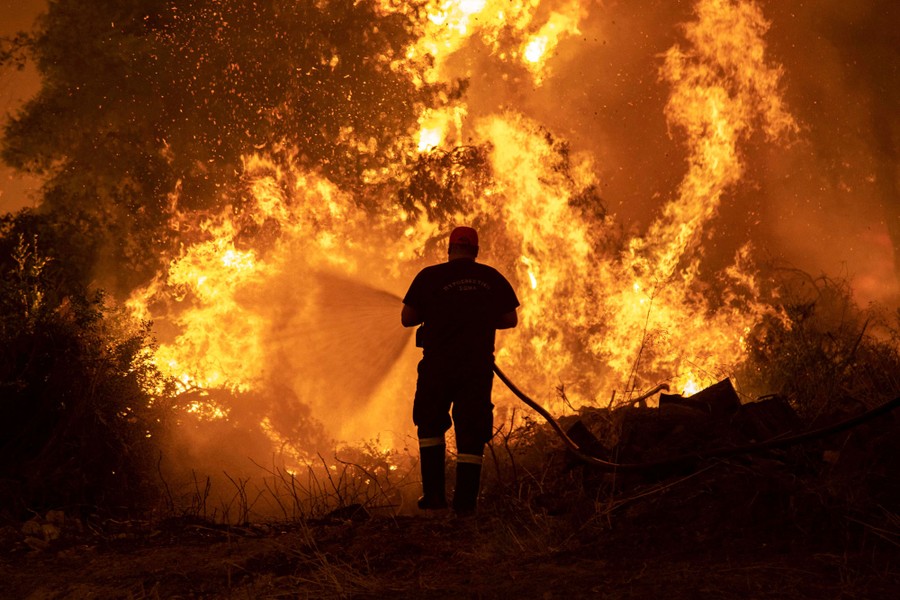 A firefighter tries to extinguish a wildfire.