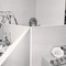 black and white photo of office cubicles with a female office worker's head visible in the back over the cubicle walls