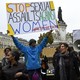Protesters carry signs, one reading "Stop sexual assaults against women #WeToogether"