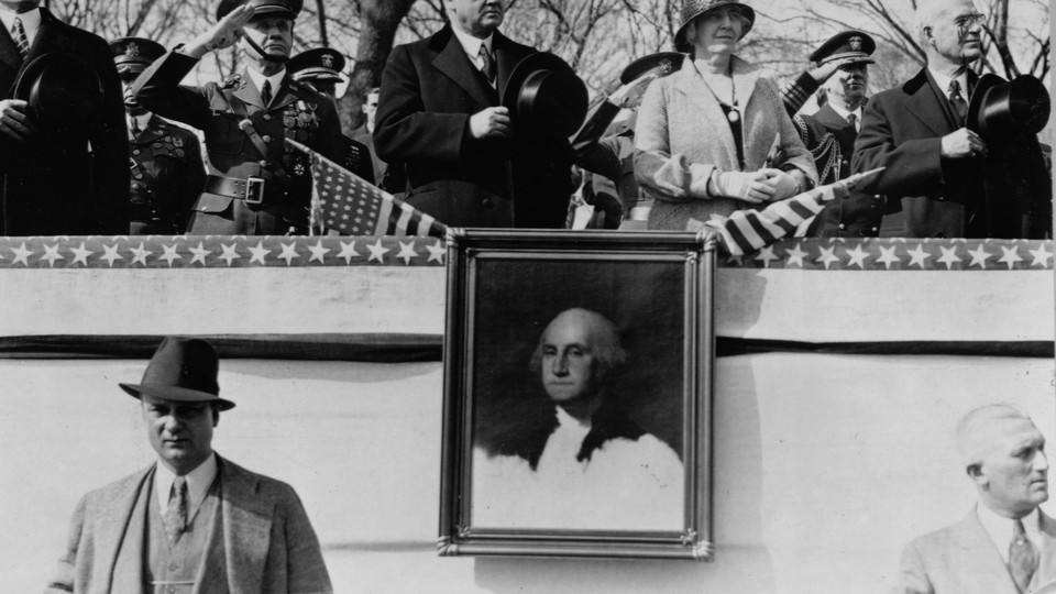 A portrait of George Washington on display during a parade
