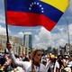 Lilian Tintori waves a Venezuelan flag amid a group of female protesters.