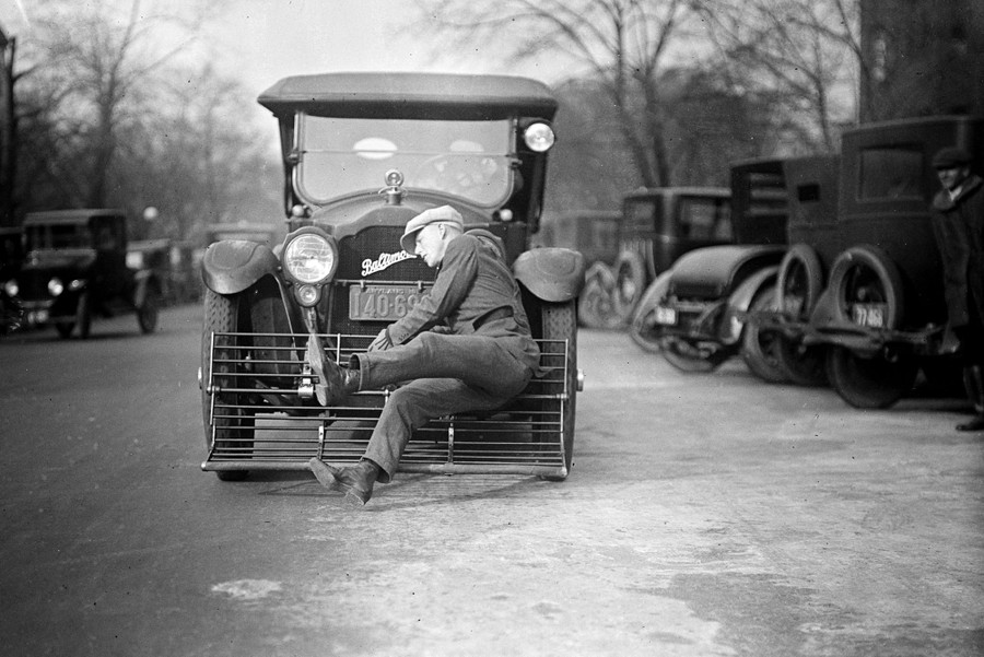 A person falls as a car with a sort of safety apparatus attached to its front bumper knocks them over.